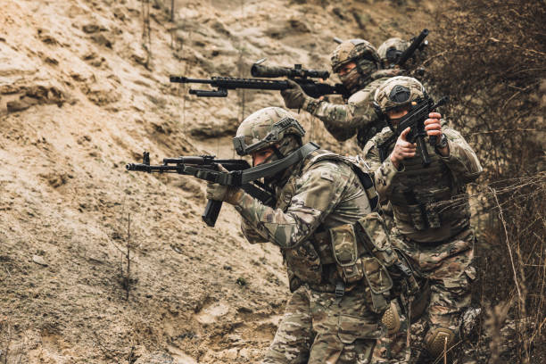 istock Group of soldiers with rifles before combat 1455011001
