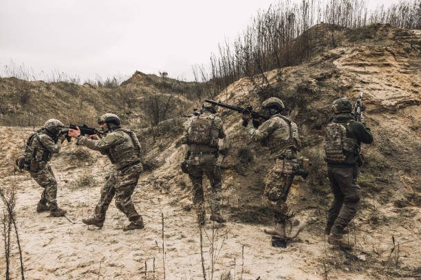 istock Soldiers on a shooting range looking concentrated and attentive 1455011007