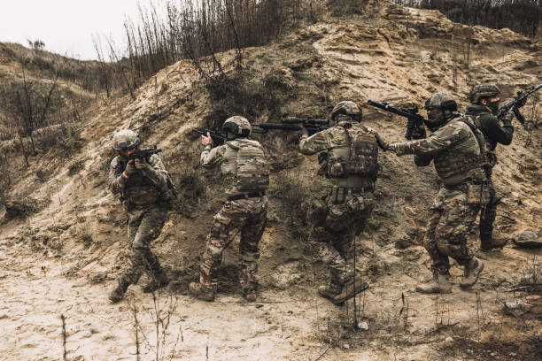 istock Soldiers on a shooting range looking concentrated and attentive 1455011009