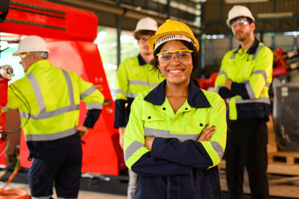 istock Group of technicians engineers workers posing to camera with smile working together at industrial factory 1455012183