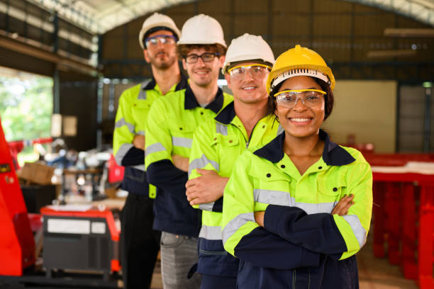 istock Group of confident engineers workers smiling looking at camera with arm crossed standing at manufacturing factory 1455012240