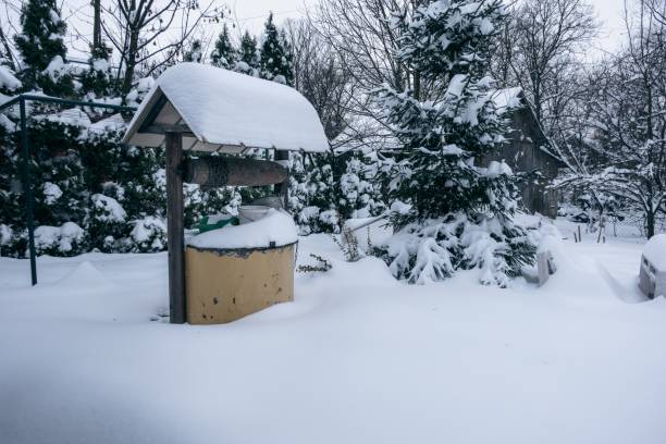 istock Well covered with white fluffy snow in a backyard in winter 1455012728