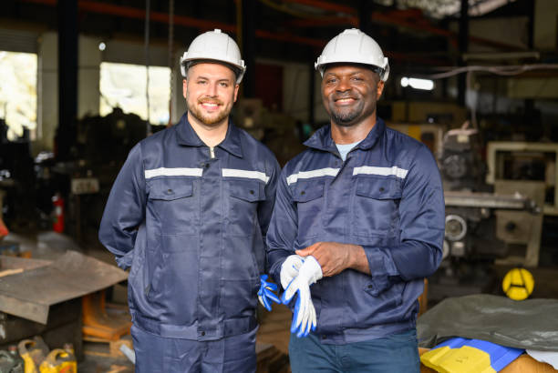 istock Two industrial engineers team with safety uniform talking and working together at manufacturing factory 1455012805
