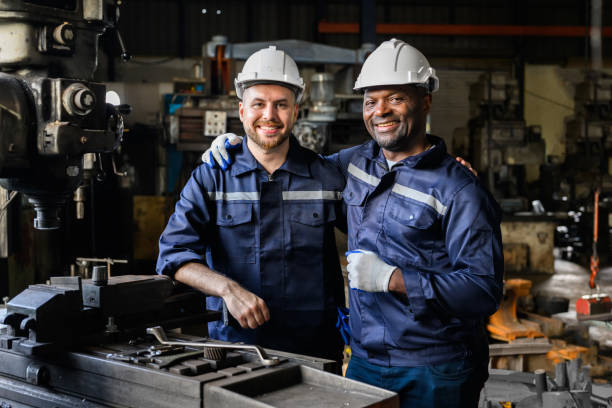 istock Two industrial engineers team with safety uniform talking and working together at manufacturing factory 1455012808