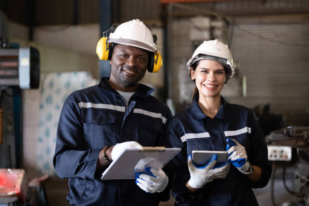 istock Two technicians engineers workers holding tablet checking and working together at factory 1455013625
