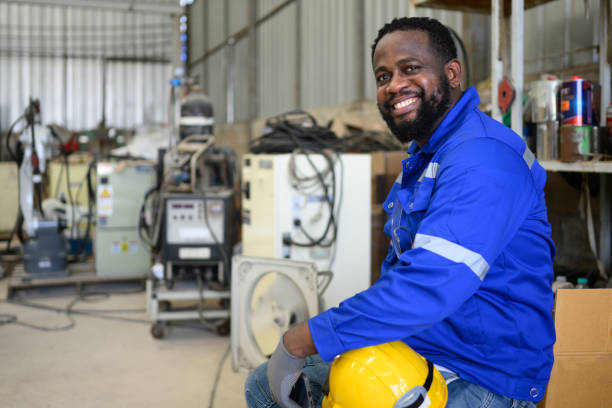 maintenance engineer with robotic arm, industrial engineer working with automatic machine at factory - african descent factory accuracy analyzing imagens e fotografias de stock