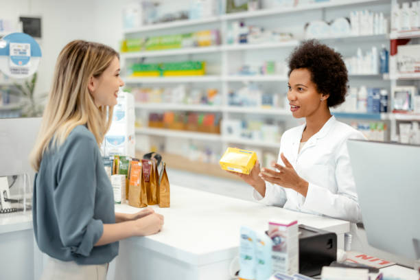 istock Female Pharmacist Helping Young Female Customer With Recommendation 1455017788