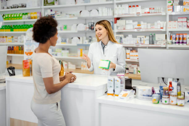 istock Female Pharmacist Giving Prescription 1455017951