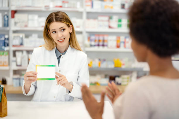 istock Female Pharmacist Giving Prescription 1455017955