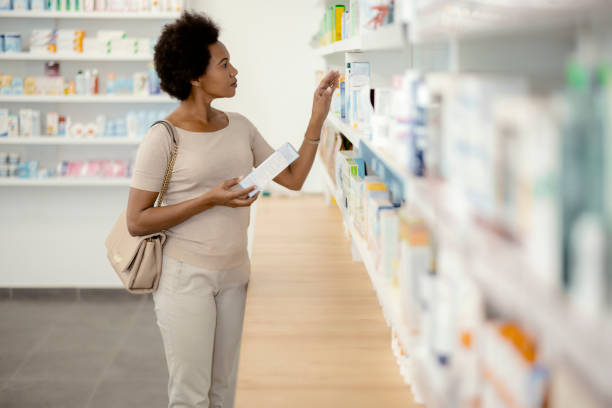 istock Female Customer Choosing Product at Pharmacy 1455018022