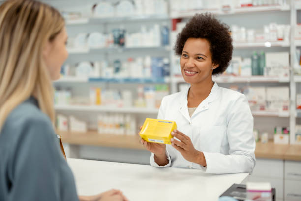 istock Female Pharmacist Helping Young Female Customer With Recommendation 1455018309