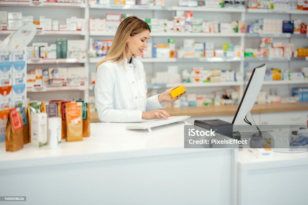Pharmacist Using Computer Female Pharmacist Using Checkout Counter Computer Stock Photo ...