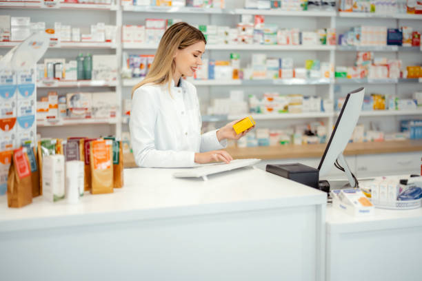 farmaceutka korzystająca z komputera kasowego - checkout counter pharmacy pharmacist patient zdjęcia i obrazy z banku zdjęć