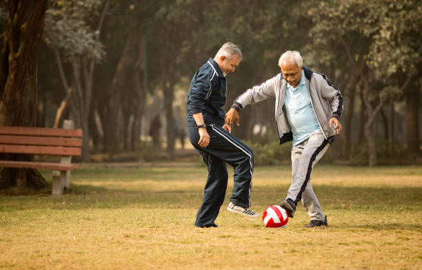 istock Old men friends playing with ball at park 1455018915