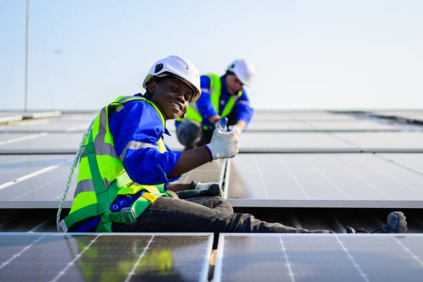 istock Professional technicians installing solar panels on rooftop of plant, Workers checking and operating system at solar cell farm power plant, Renewable energy source for electricity and power, Solar cell maintenance concept 1455018920