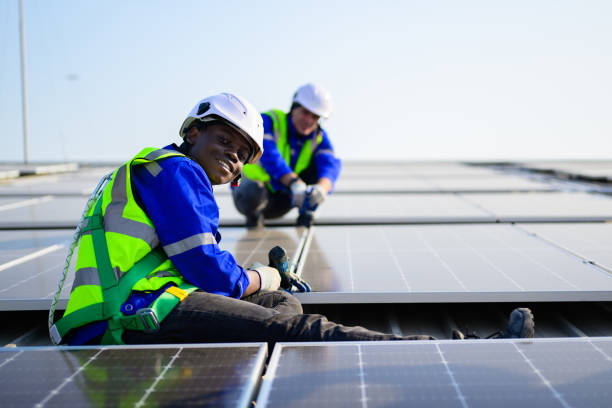istock Professional technicians installing solar panels on rooftop of plant, Workers checking and operating system at solar cell farm power plant, Renewable energy source for electricity and power, Solar cell maintenance concept 1455019182