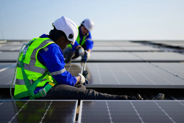istock Professional technicians installing solar panels on rooftop of plant, Workers checking and operating system at solar cell farm power plant, Renewable energy source for electricity and power, Solar cell maintenance concept 1455019211