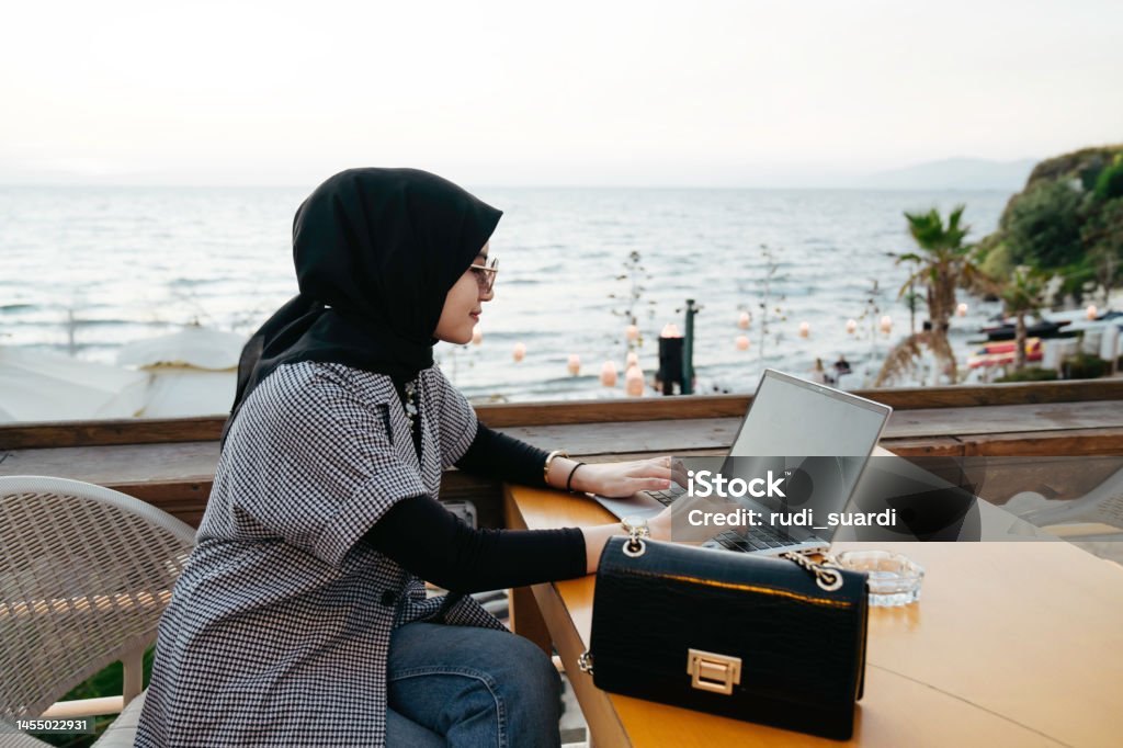 asian muslim woman working during holiday  in the tourist resort Travel Stock Photo