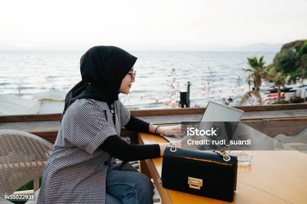 Asian Muslim Woman Working During Holiday In The Tourist Resort Stock Photo - Download Image Now