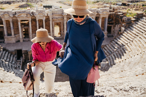 senior Tourist in the Ancient Roman Amphitheater Ruin the The Holy City of Hierapolis next to the Pamukkale hot springs in Western Turkey built in the 2nd Century and is now a UNESCO World Heritage Stie