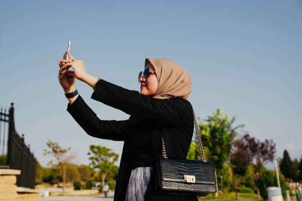 istock asian woman using phone during sunny day 1455023347