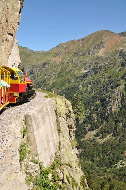 istock Train passing a vast mountainous landscape in the countryside 1455024699