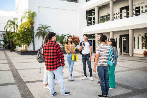 istock Young friends talking at university 1455025051