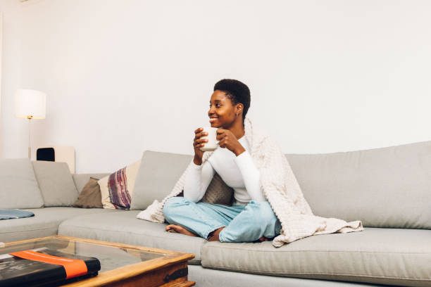 istock a person sitting on a sofa 1455025104