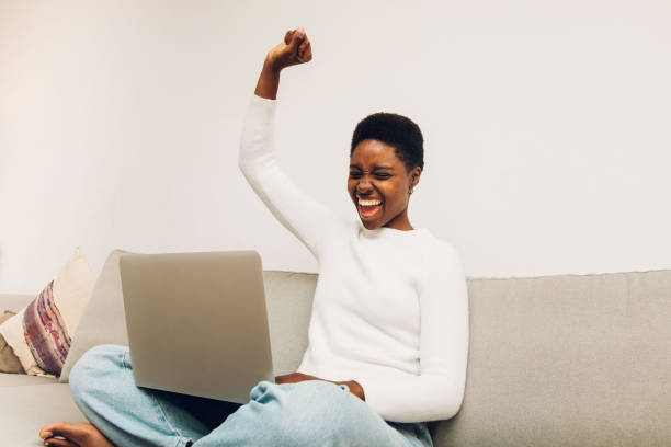 istock a person with laptop gesturing celebration 1455025250