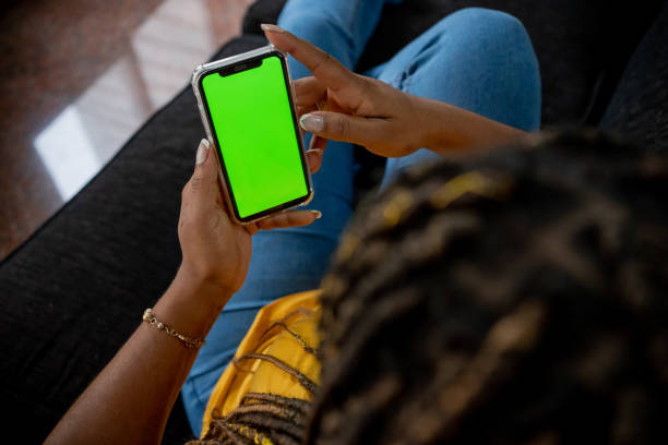 istock Black woman using cell phone at home 1455026993