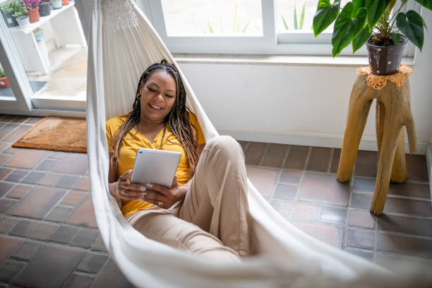istock Black woman using tablet at home 1455027260