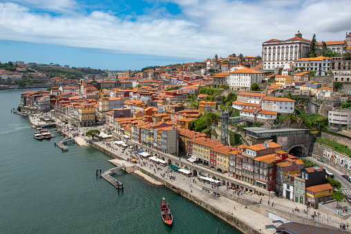 High angle view of the old town of Porto with colorful buildings at the Cais de Ribeira along the Duoro river.
