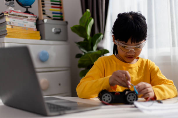 istock Asia students learn at home in coding robot cars and electronic board cables in STEM, STEAM, mathematics engineering science technology computer code in robotics for kids concept. 1455031376