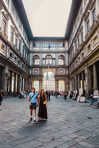Florence, Italy - October 18, 2022: Uffizi Gallery in Piazzale degli Uffizi, the most famous Italian Museum Gallery. There are tourists and artists exposition in the courtyard of the gallery.