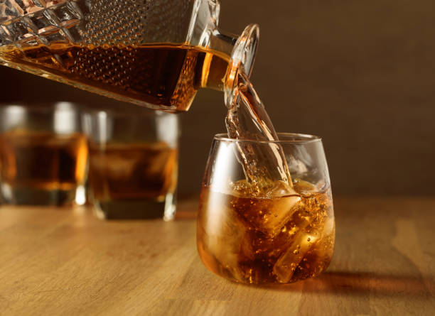 istock Whiskey is poured into a dammed glass with ice. 1455036798