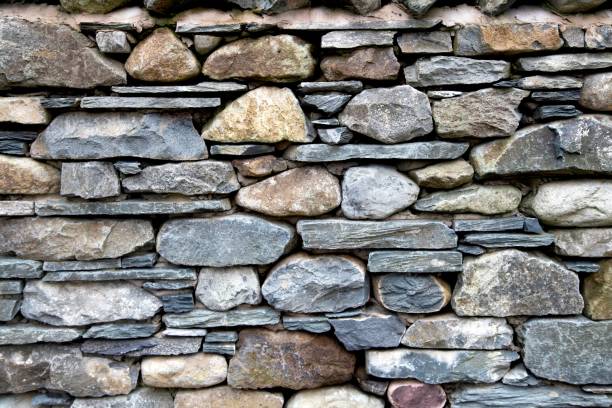 istock Closeup shot of a gray stone wall with different rocks 1455039897