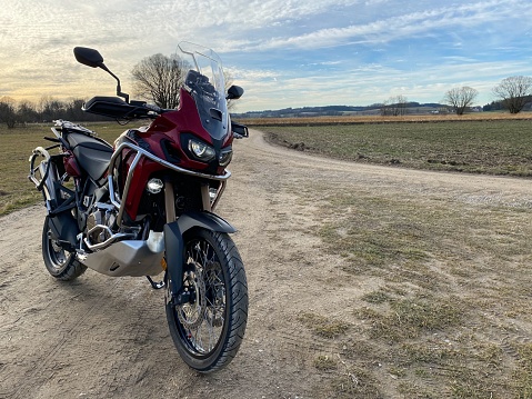 Munich, Germany – June 30, 2019: A parked CRF1000L Honda Africa Twin adventure bike on a dusty trail