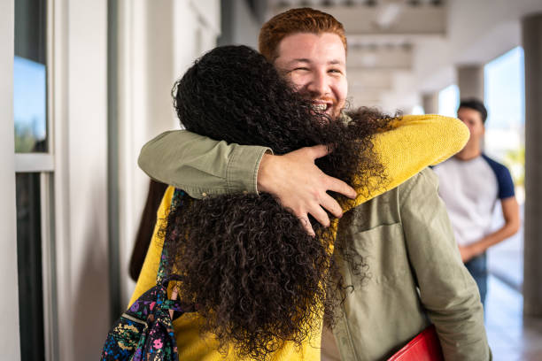 istock Young man embracing his friend at university 1455042619