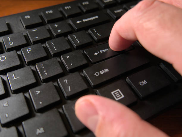 istock A person's hand pressing the Enter key on a black computer keyboard. Close up, macro shot 1455043994