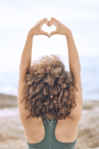 Black woman afro, heart sign and stretching in wellness, exercise or healthy lifestyle in the outdoors. African American female in morning expression or stretch with hands for love gesture or emoji