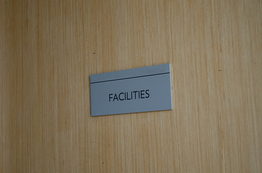 Sign in a door indicating the the facilities area is behind it.