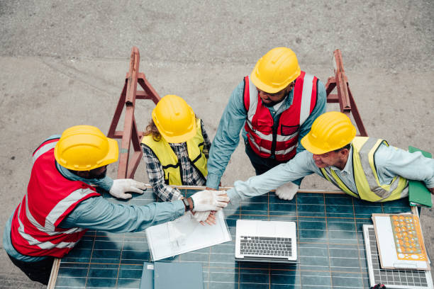 istock Group of professional engineer people meeting and join hand together. 1455051111