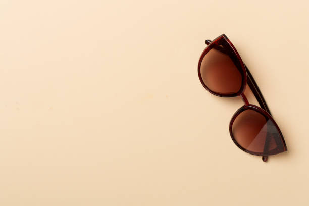 istock Sunglasses on color background, top view 1455052489