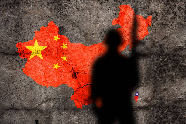 istock China and Taiwan flags painted on a concrete wall with soldier shadow 1455057188