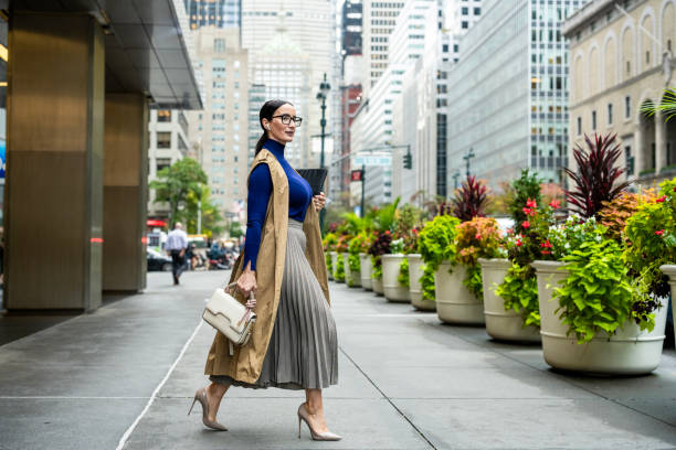 istock Nicely dressed businesswoman seen exiting the building in Manhattan after work 1455057897