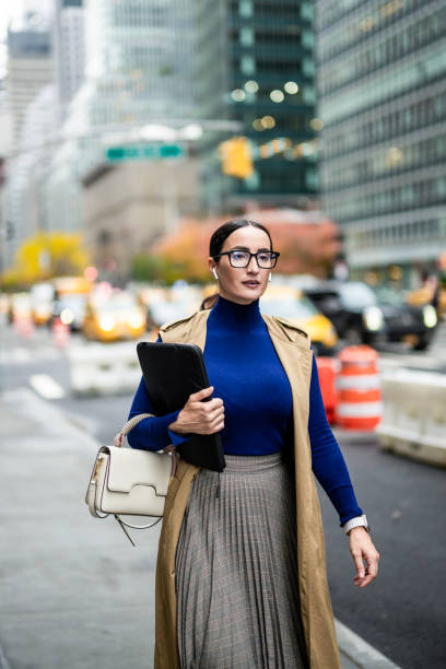 istock Nicely dressed businesswoman seen exiting the building in Manhattan after work 1455058439