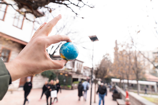 a man holding a globe. Conceptual with space for copy. personal perspective view