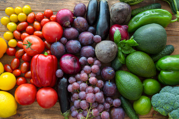 istock Assortment of rainbow fruits and vegetables on brown rustic background. 1455065647