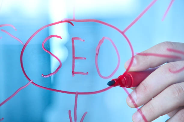 istock Businessman hand writing SEO diagram on glass screen. 1455065853