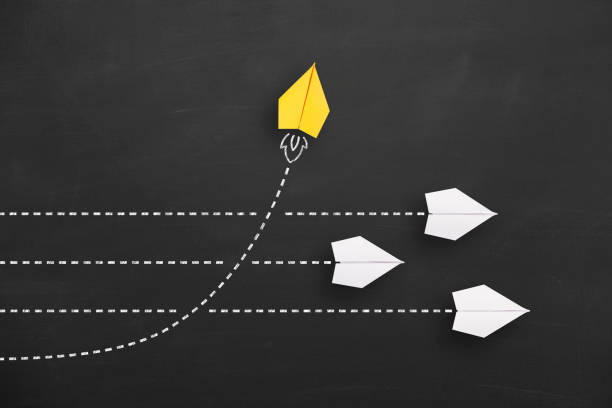 istock Change concepts with yellow paper airplane leading among white 1455070468